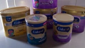a bunch of Enfamil baby formula on a counter top