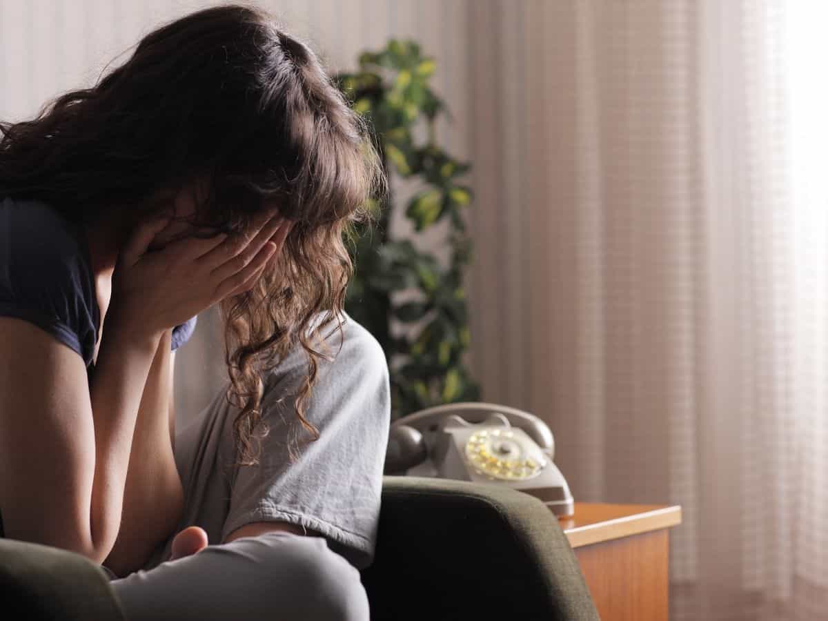 a mom sitting alone crying