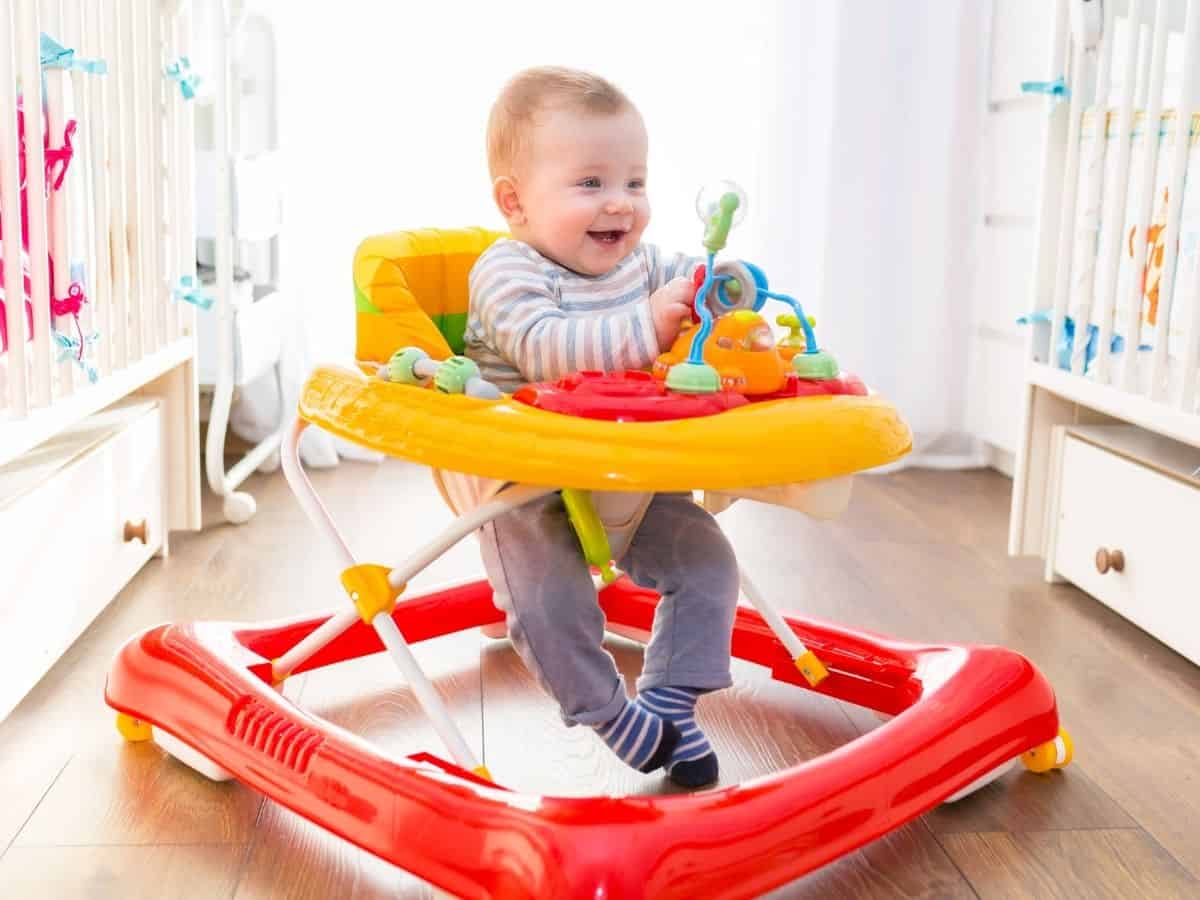 an 1 year old playing in a baby walker