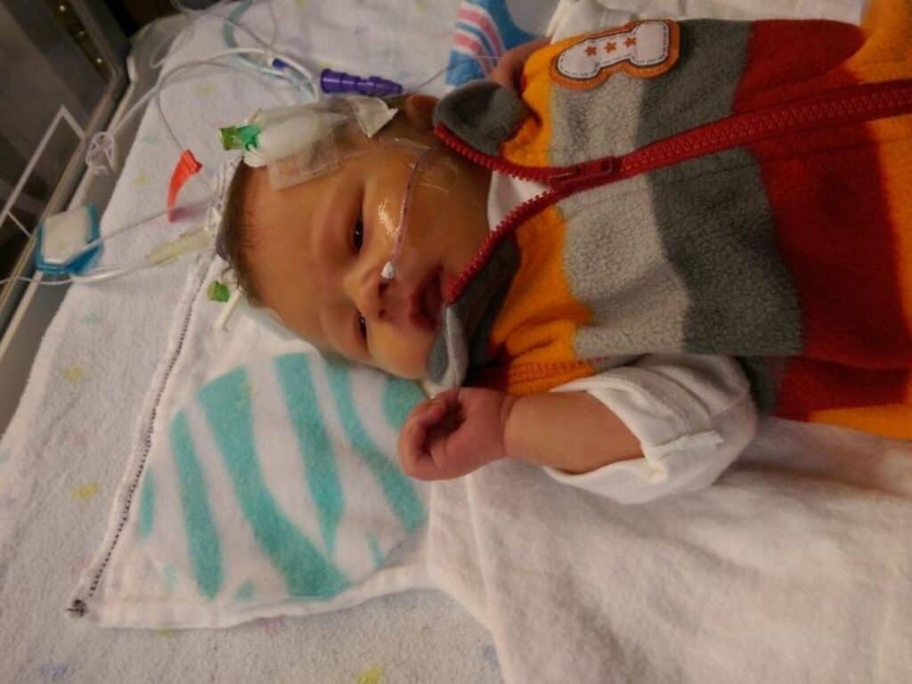 a baby in the nicu with a scent circle near him
