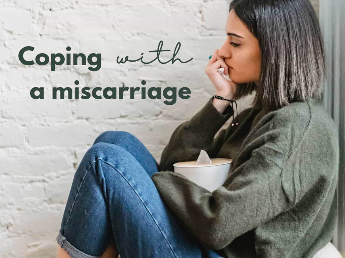 a sad woman with text overlay that reads coping with a miscarriage