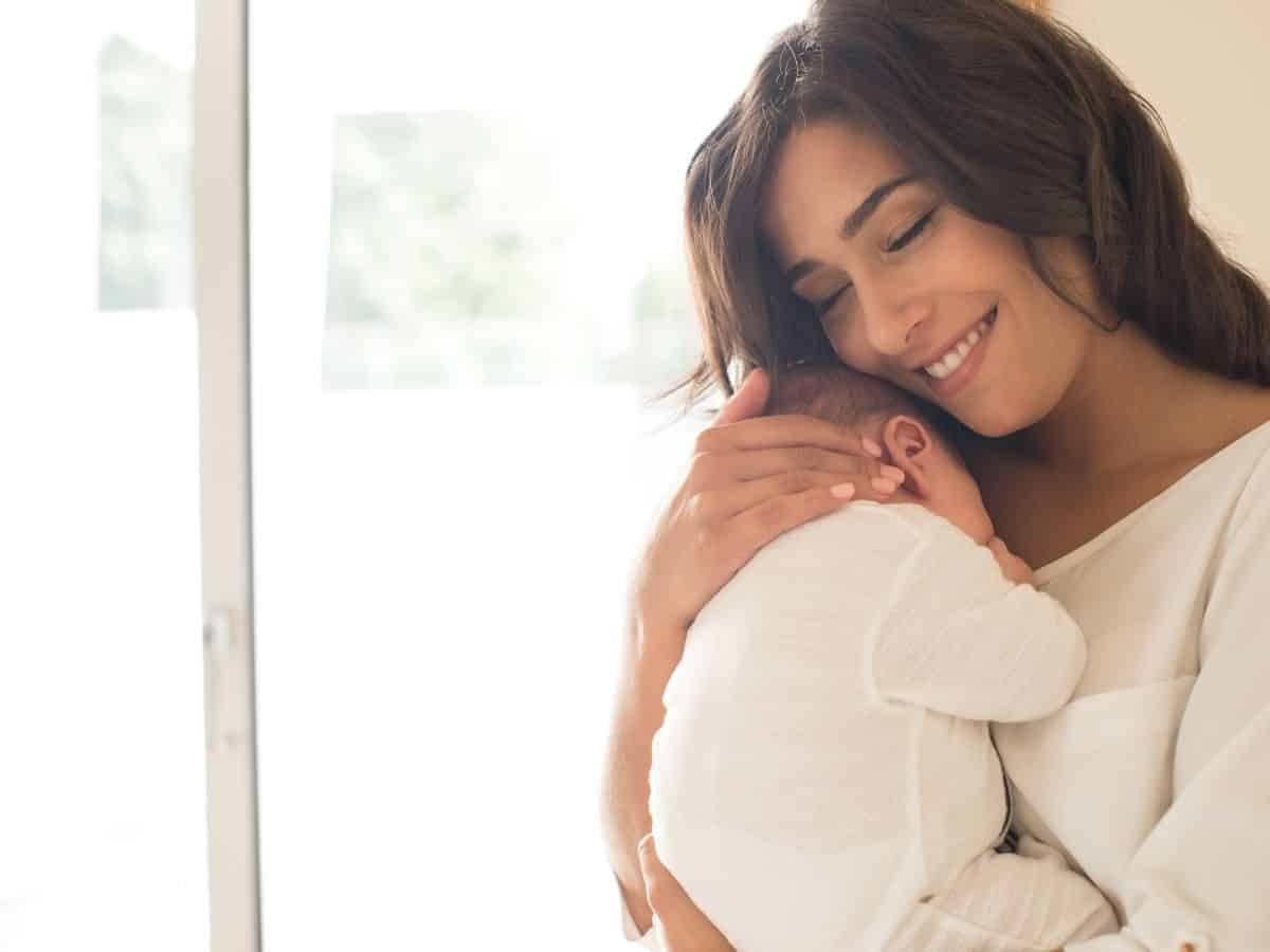 a mom holding her newborn baby