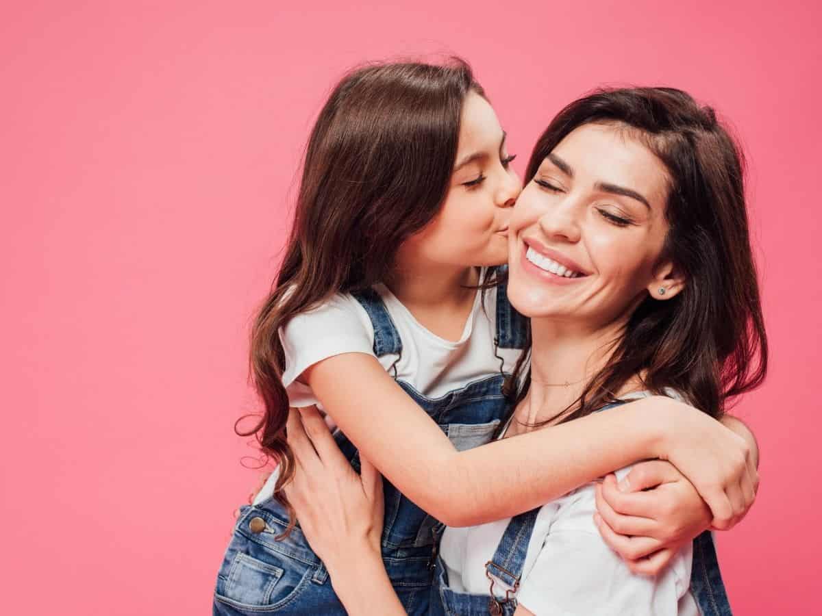 a mom and daughter hugging