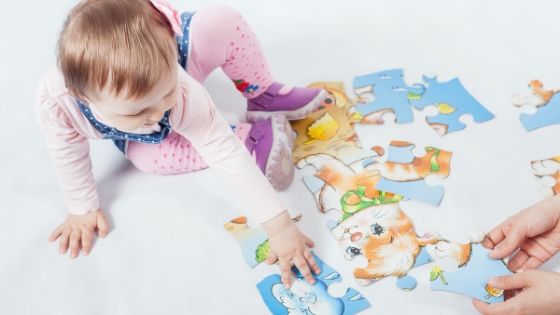 a young child putting a puzzle together