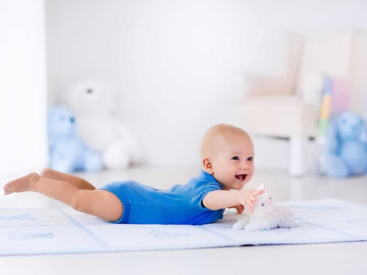 a baby boy doing tummy time on a mat