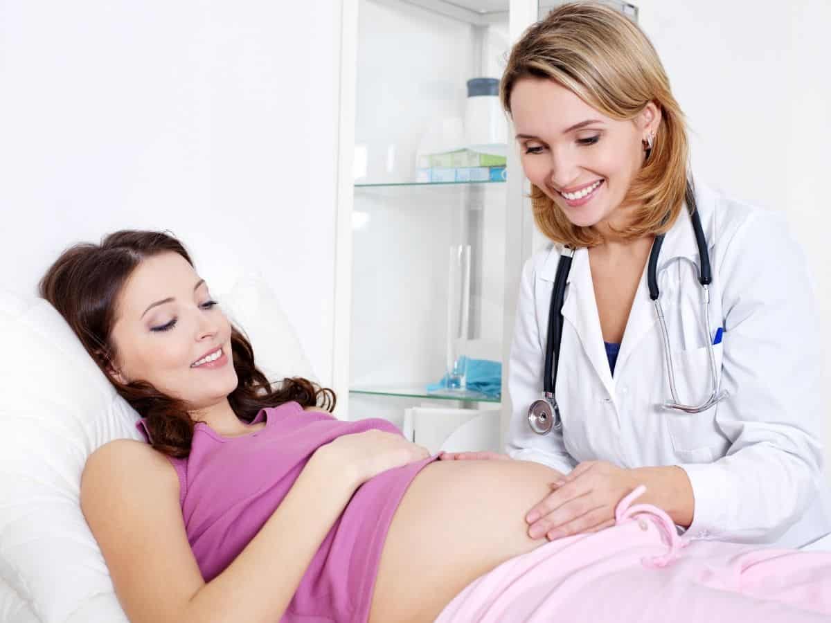 a pregnant woman in a doctor's office with her obgyn