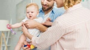Mom helping dad and baby bond