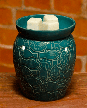 a wax warmer with fish engraved on it