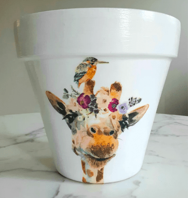 a planter with a painted giraffe on it