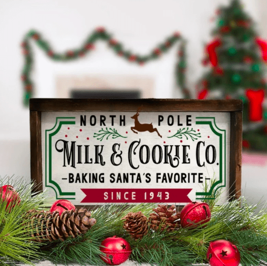 A christmas decoration sign that says north pole milk and cookie co baking santas favorite since 1943