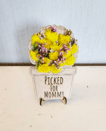 a flower stand that says picked for mommy