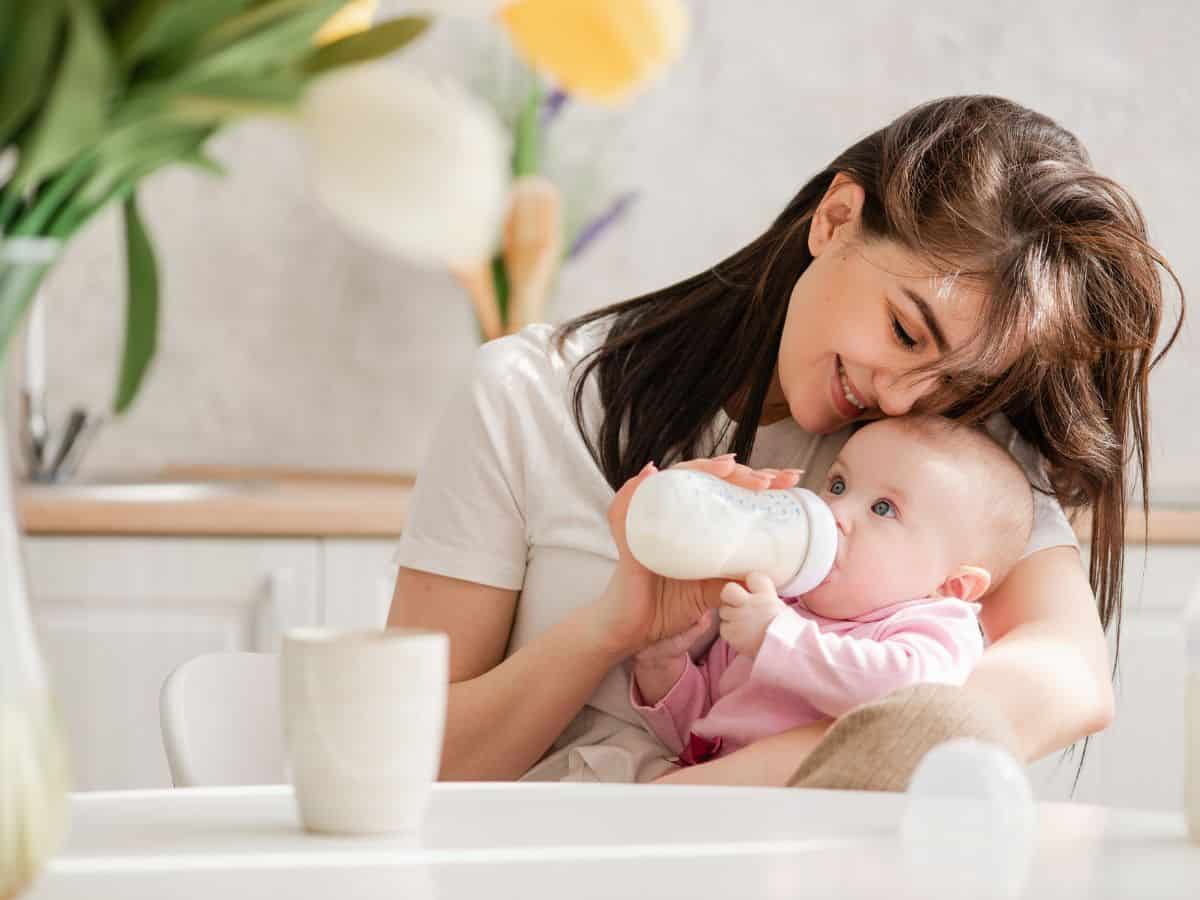 a mom feeding her baby a bottle