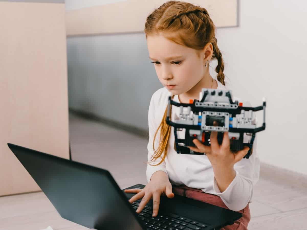 a girl focused on her STEM project with her computer