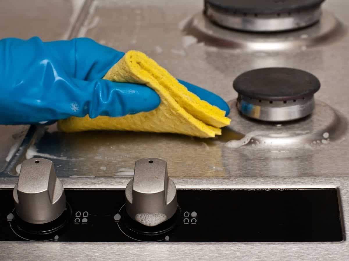 cleaning the stove top under the burners