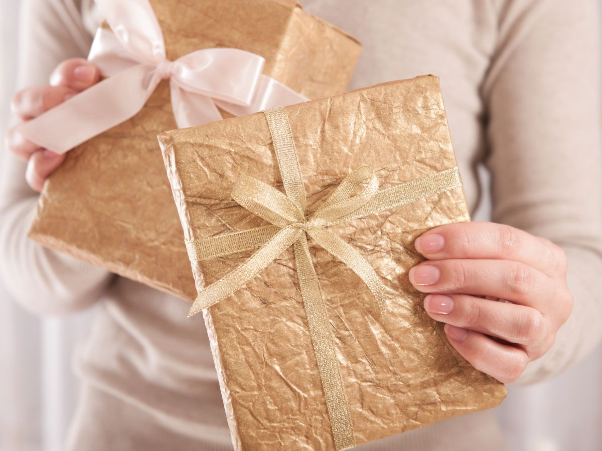 a woman holding two gift wrapped presents