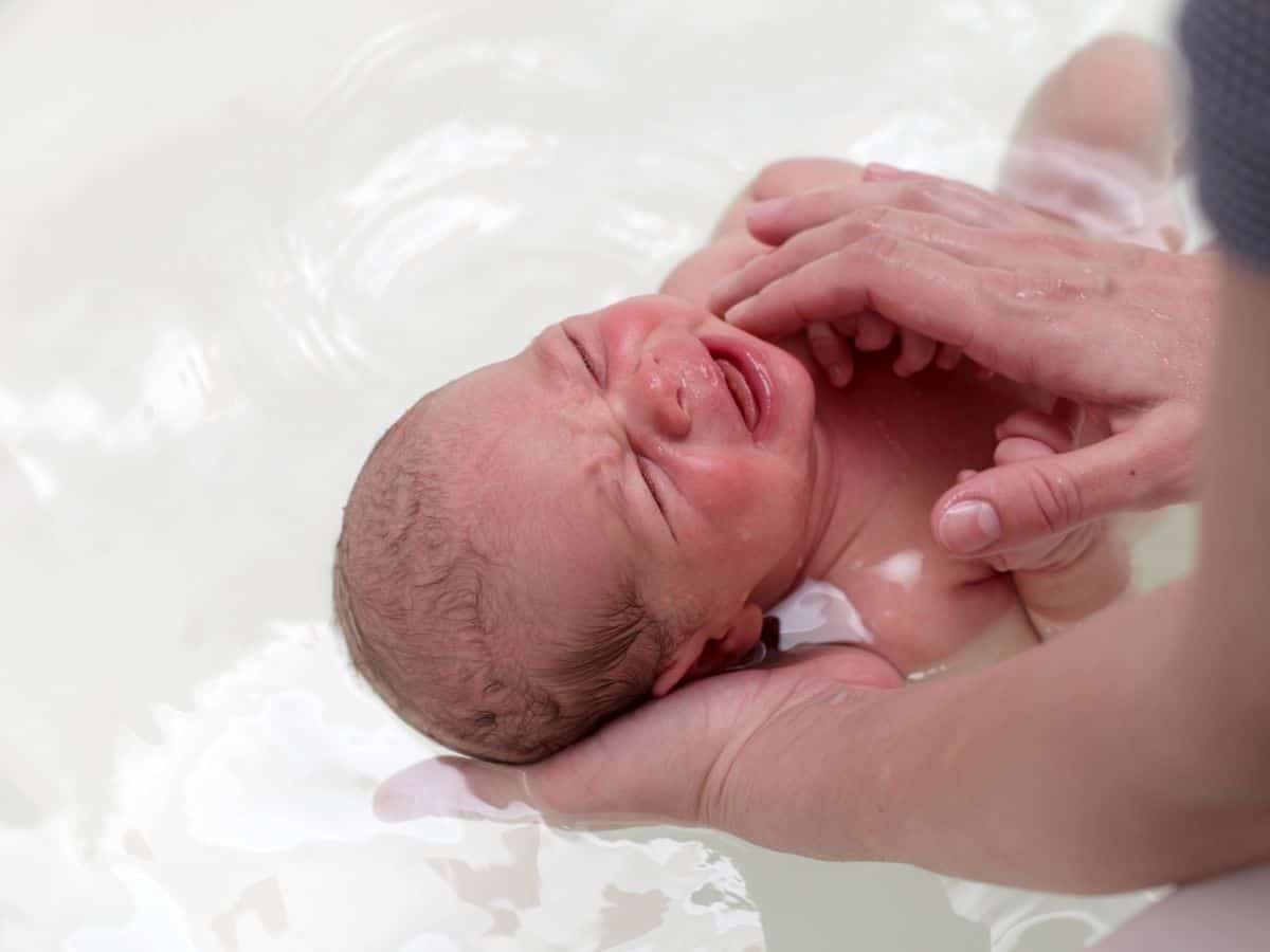 a newborn getting a bath