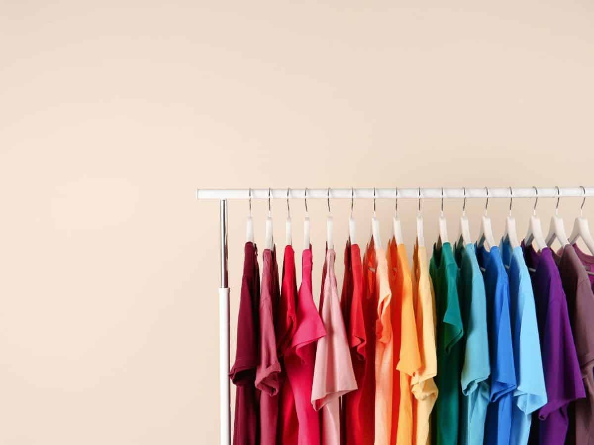 shirts organized by color on a clothing rack