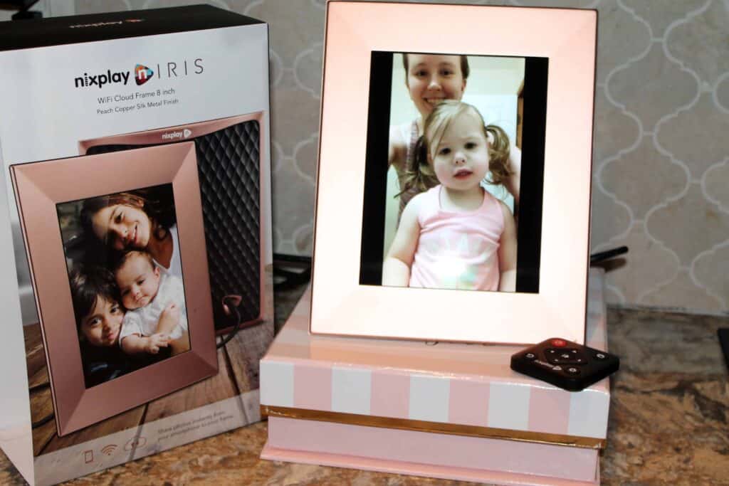 rose gold digital photo frame displaying a picture of a mom and daughter