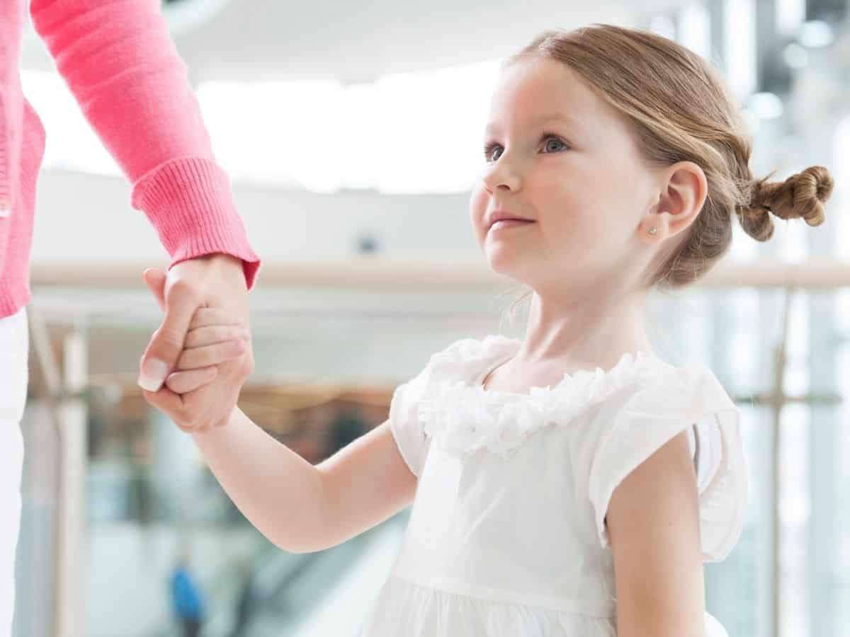 a child holding her moms hand