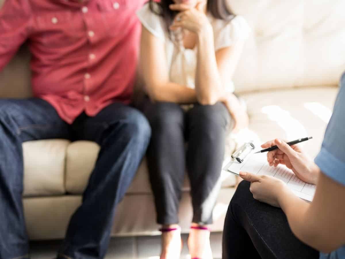 a married couple attending a therapist session together.