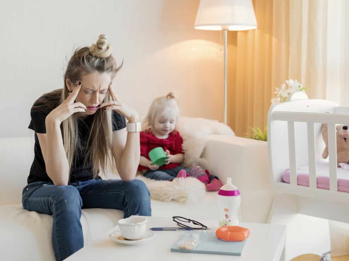 a frustrated mom sitting next to her daughter on the couch