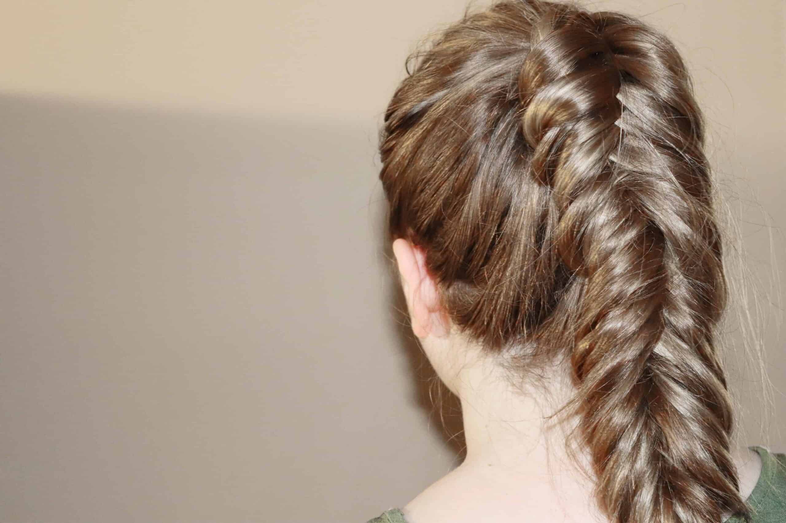 a woman with a fishtail braid on her ponytail