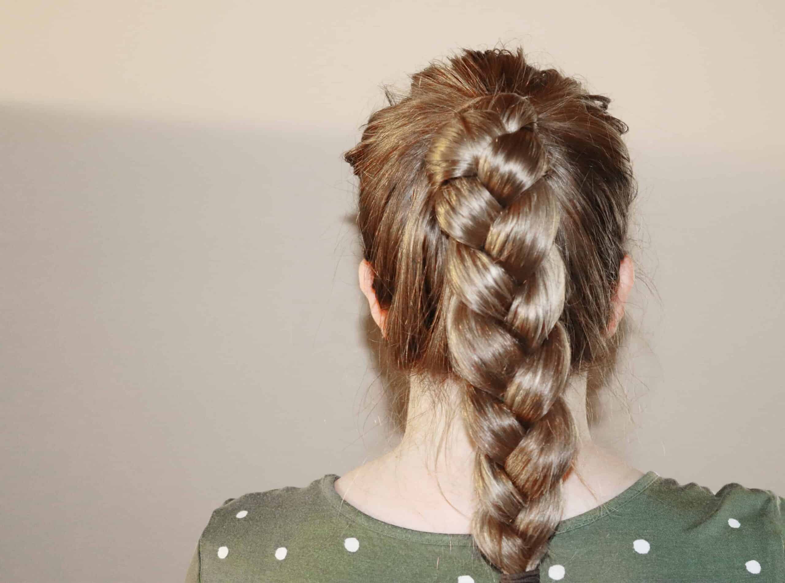 a woman with a braided ponytail