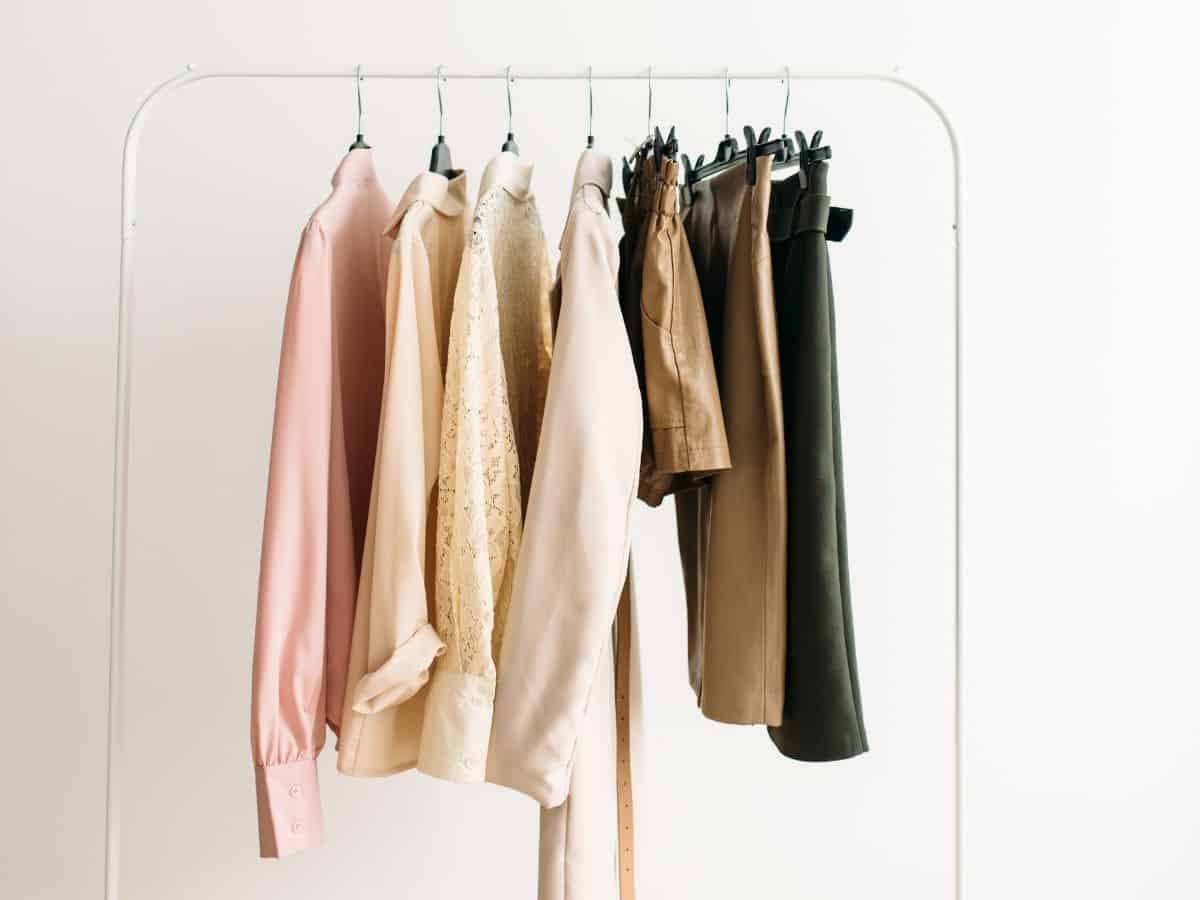 seven pieces of clothing hung on a clothing rack