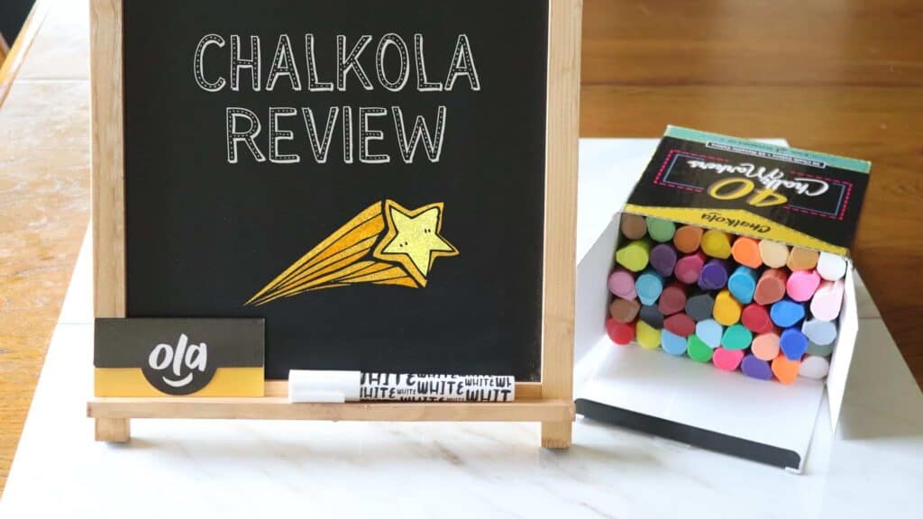 a chalk board standing next to a box of liquid chalk markers