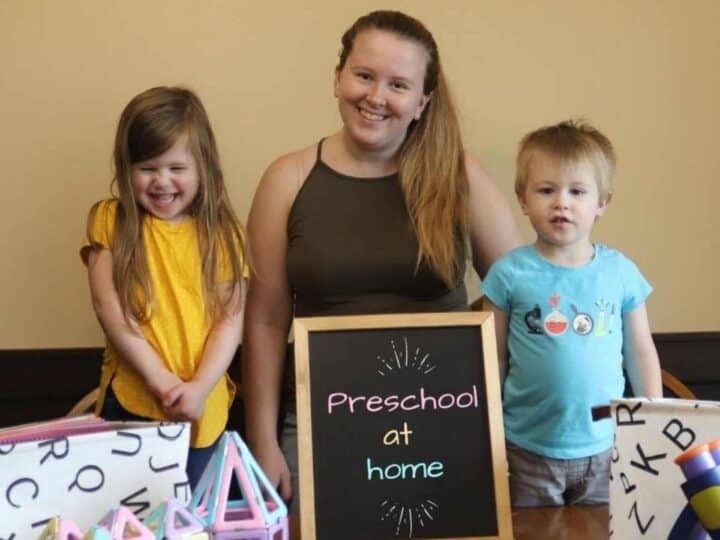 a mom with her kids and a chalkboard that says preschool at home