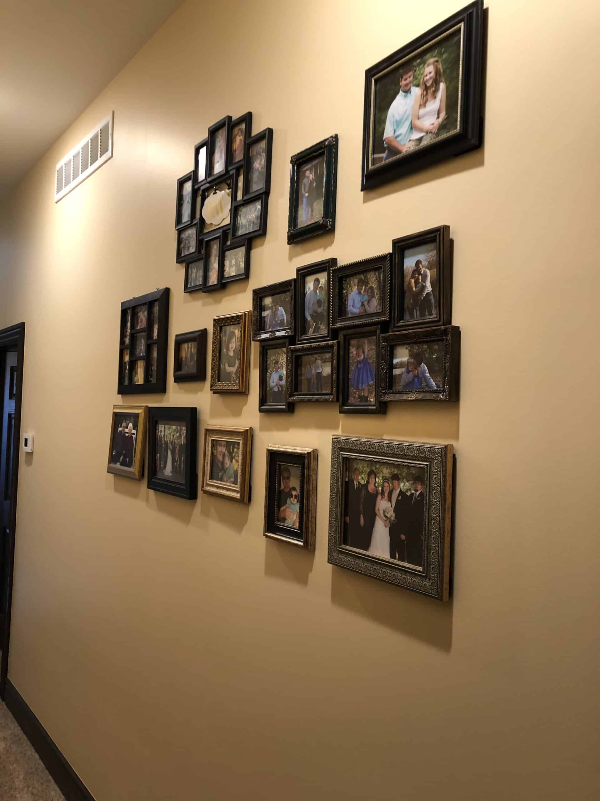 a hallway with picture frames hung up on the wall