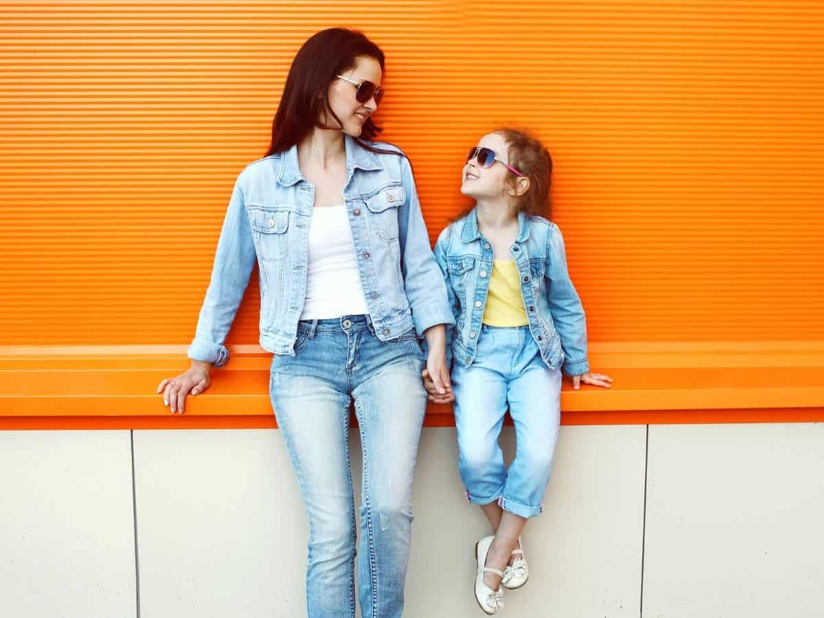 a stylish looking mom and daughter posing for a camera