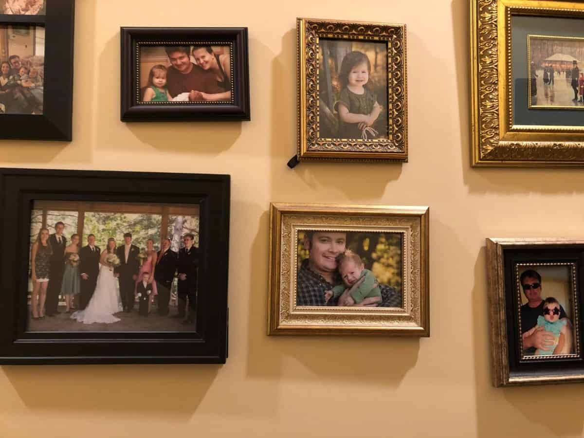 a gallery wall with mix and match picture frames and photos