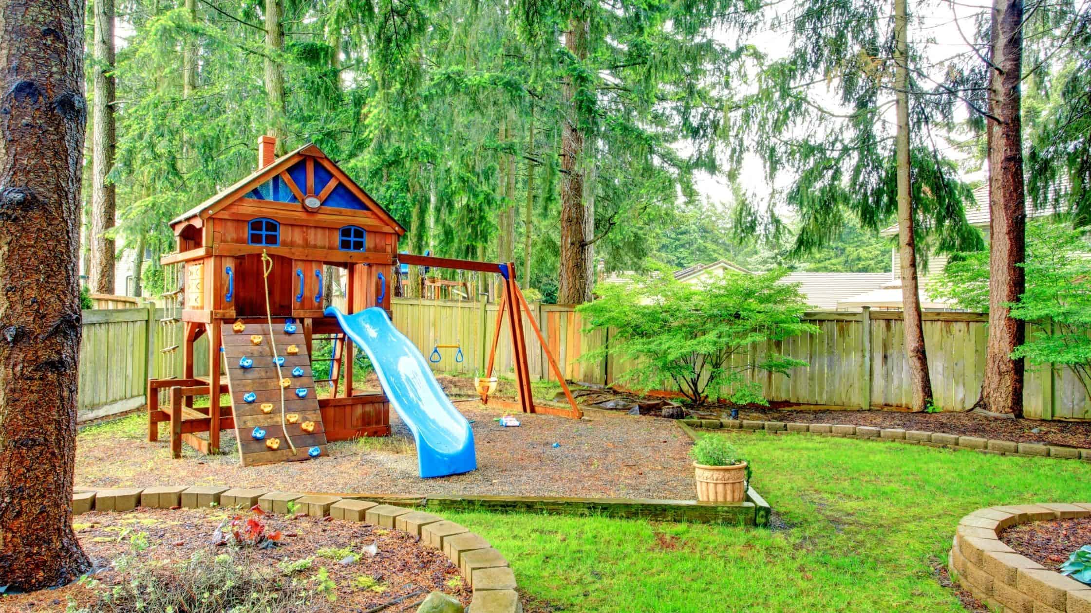 a fun playground set in a backyard of a home