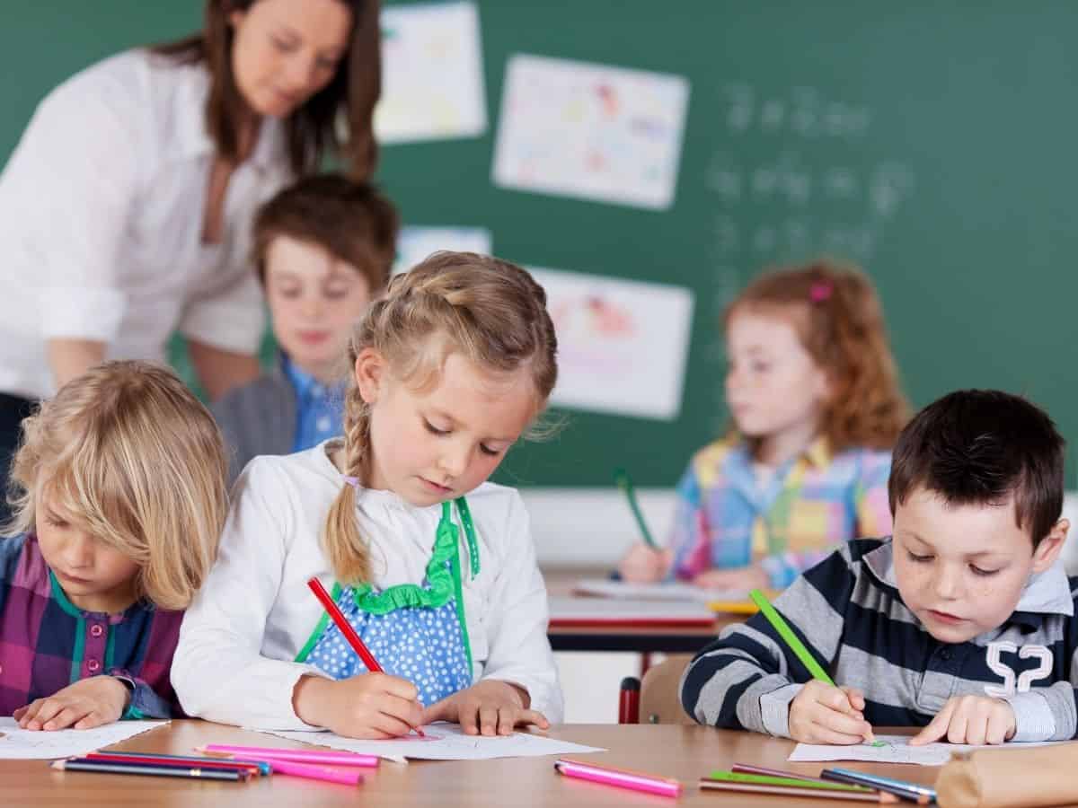 a kindergarten class with kids and a student