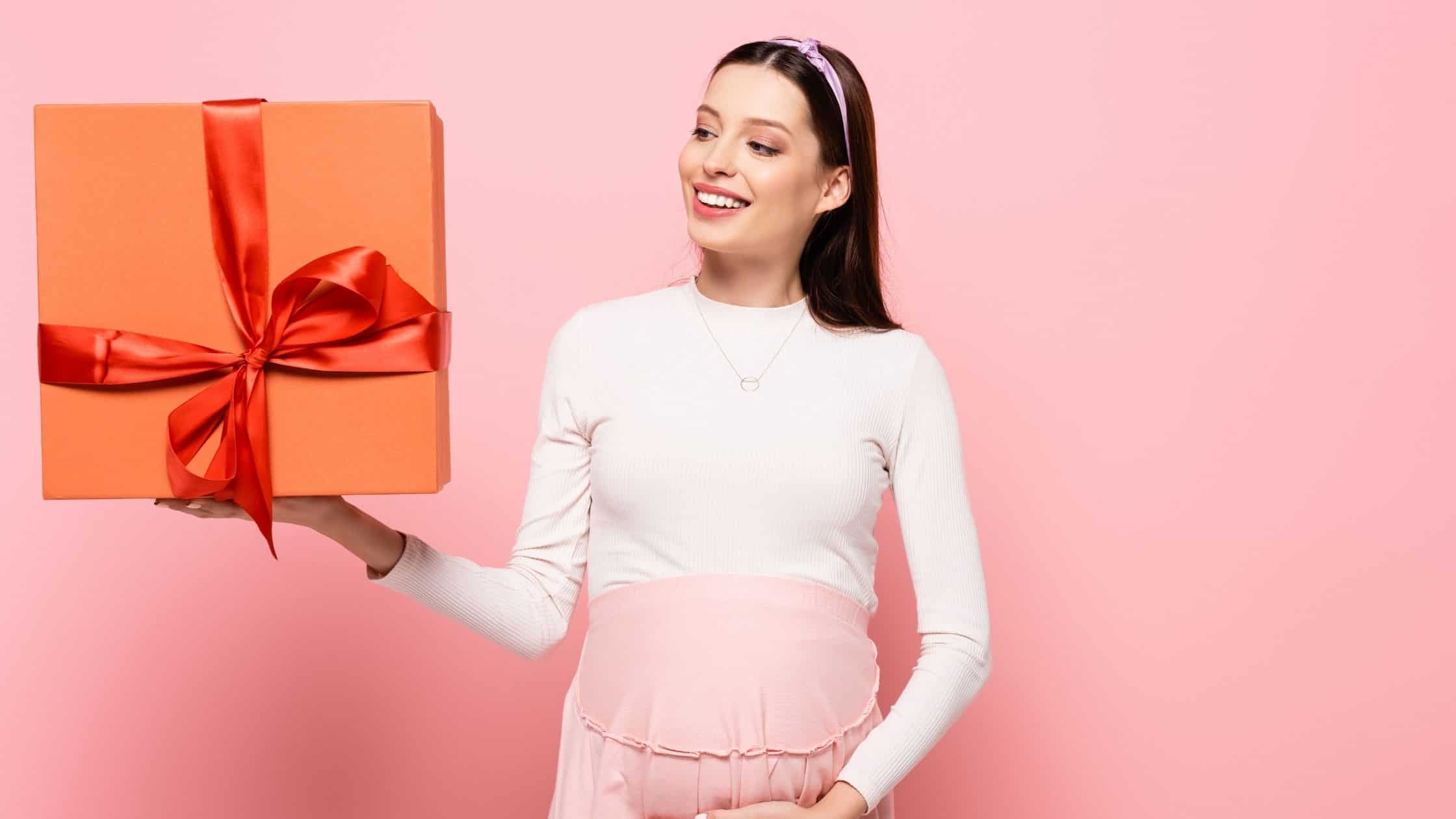 a pregnant woman holding a present