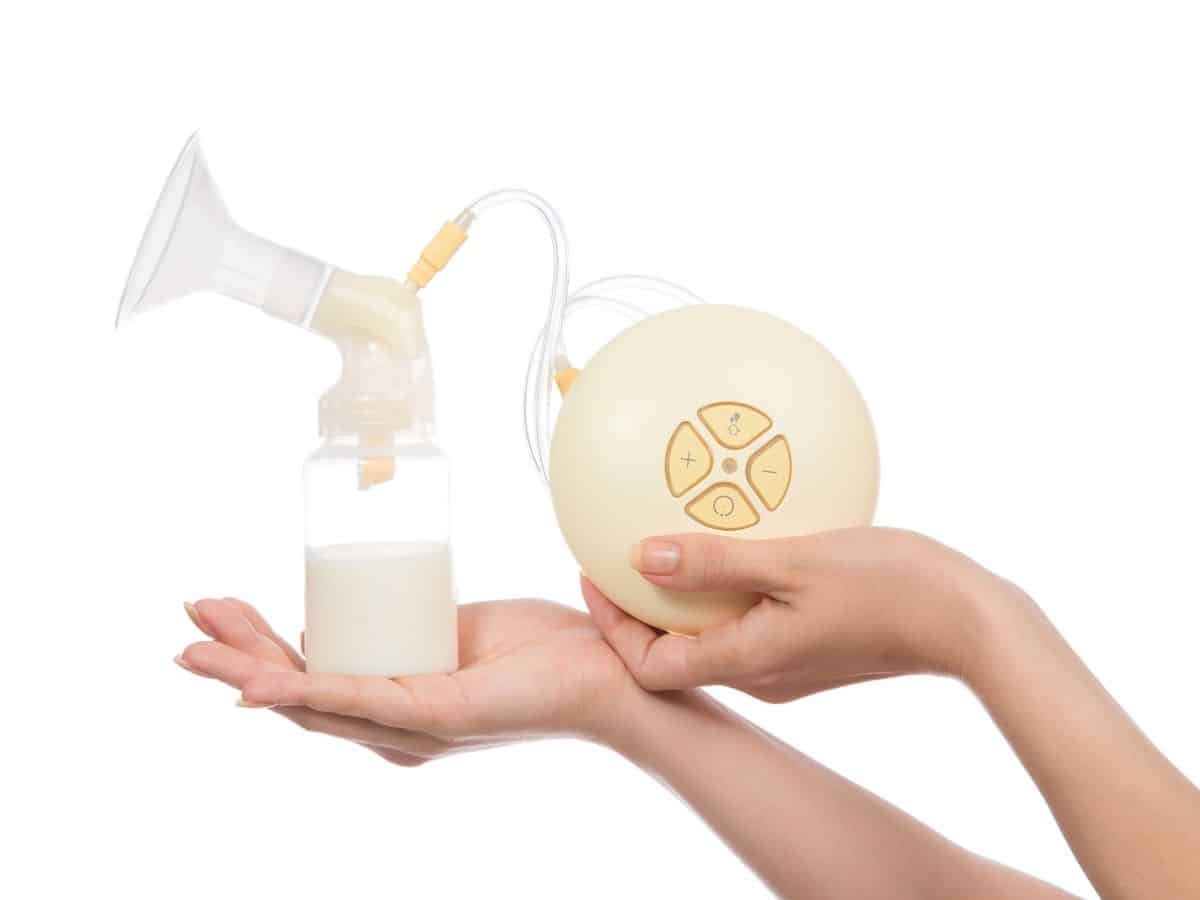 a woman holding a breast pump with breast milk in the bottle
