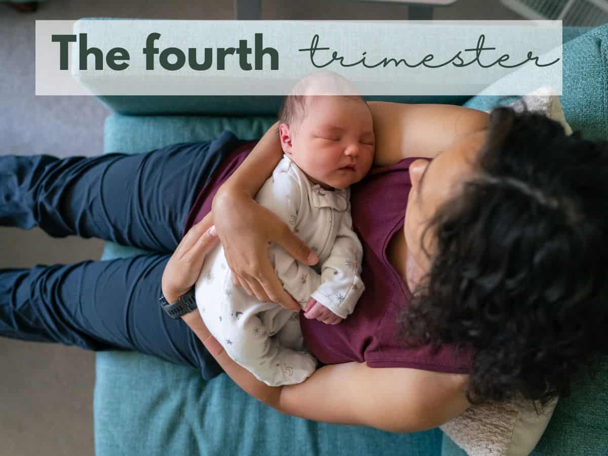 a mom holding her baby on the couch with text overlay that reads the fourth trimester