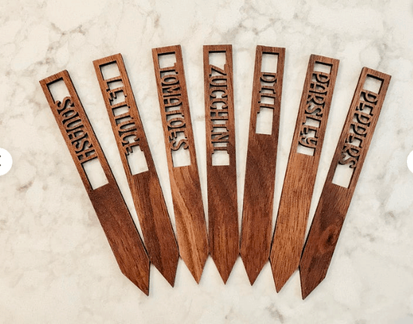 wooden garden stakes with custom engraved names of vegetables and herbs