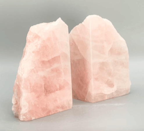 two book ends made out of natural rose quartz