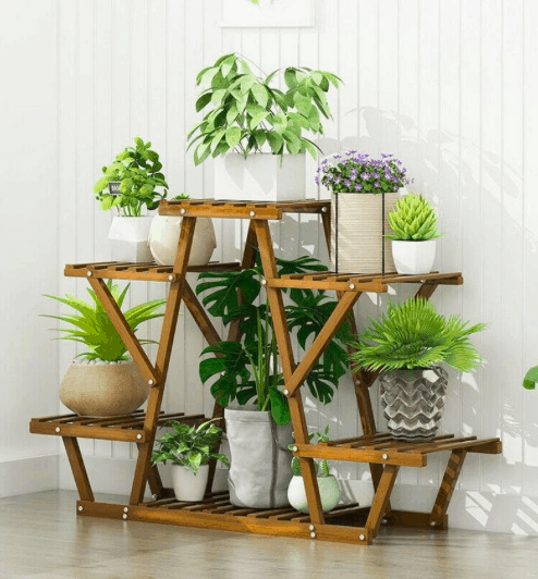 a wooden plant stand that allows for plants to drain