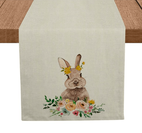 a table runner with a bunny and some flowers on the ends