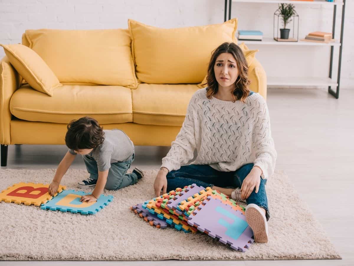 a mom sitting next to her son with a look of frustration on her face