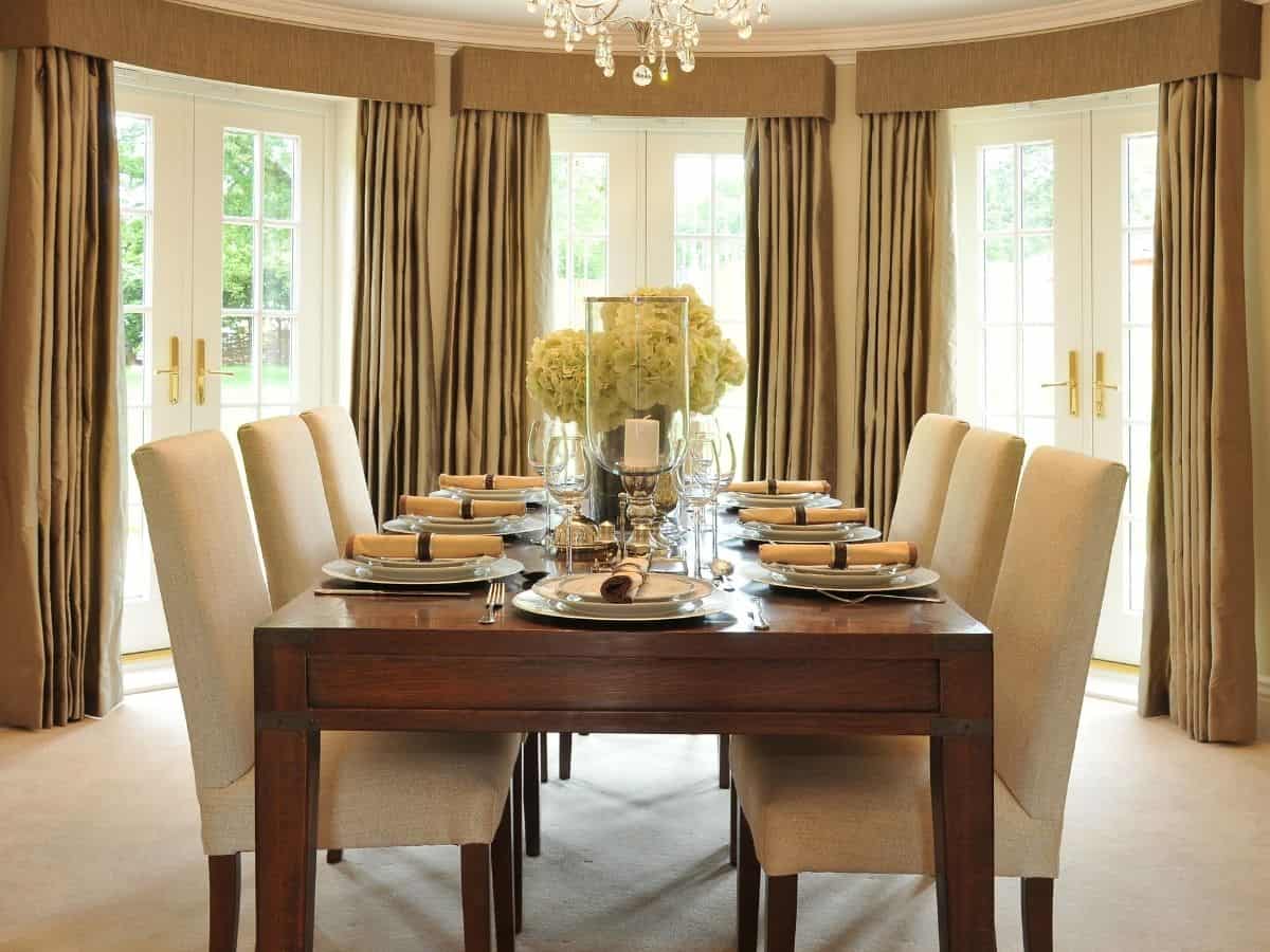 a formal dining room with beautiful upholstered chairs and place settings for six