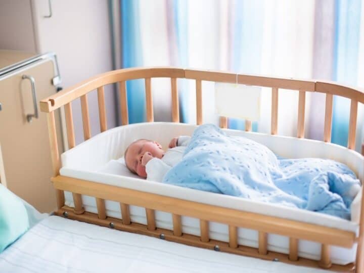 a baby sleeping in a bassinet