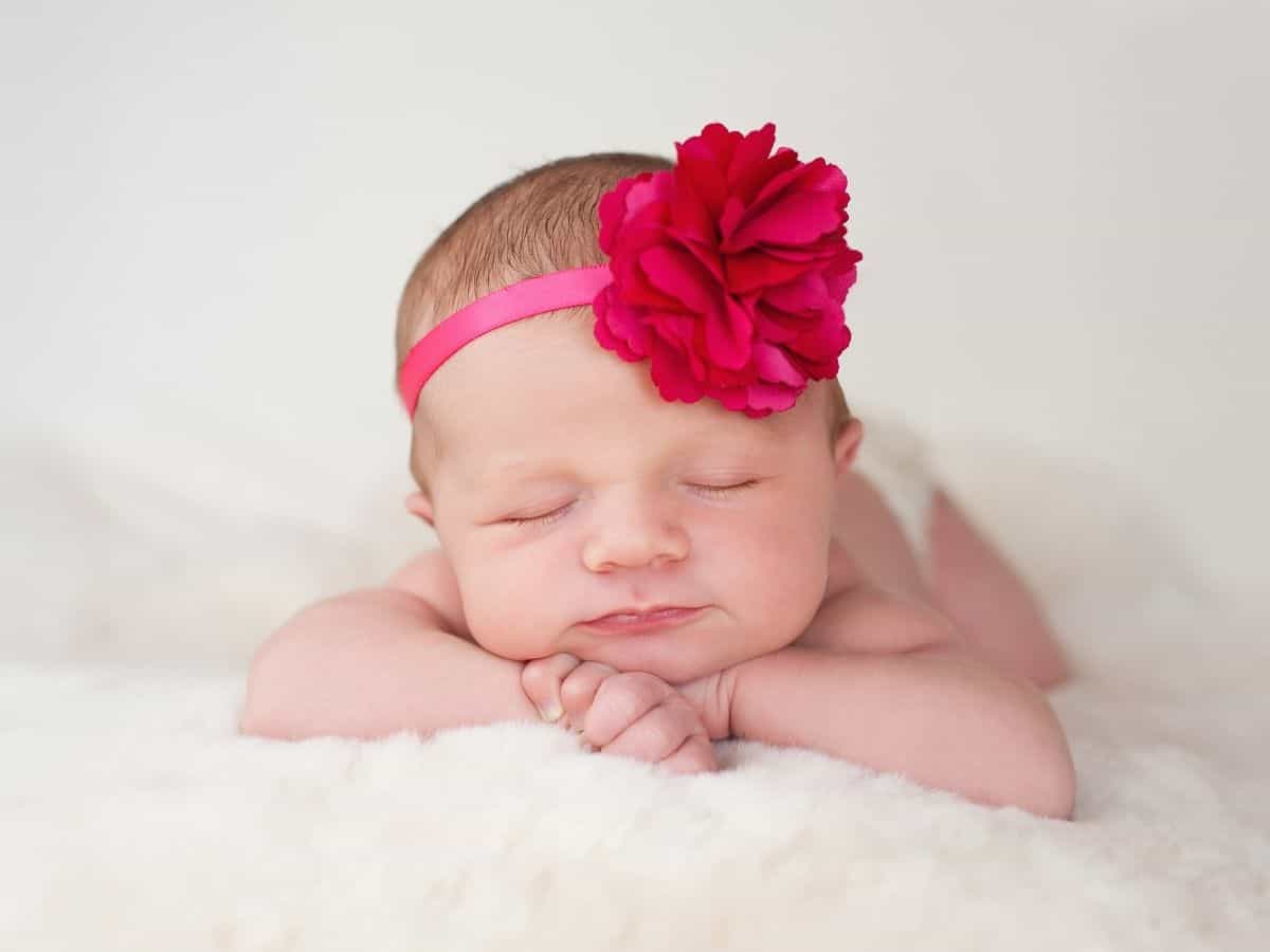 a baby girl with a flower headband