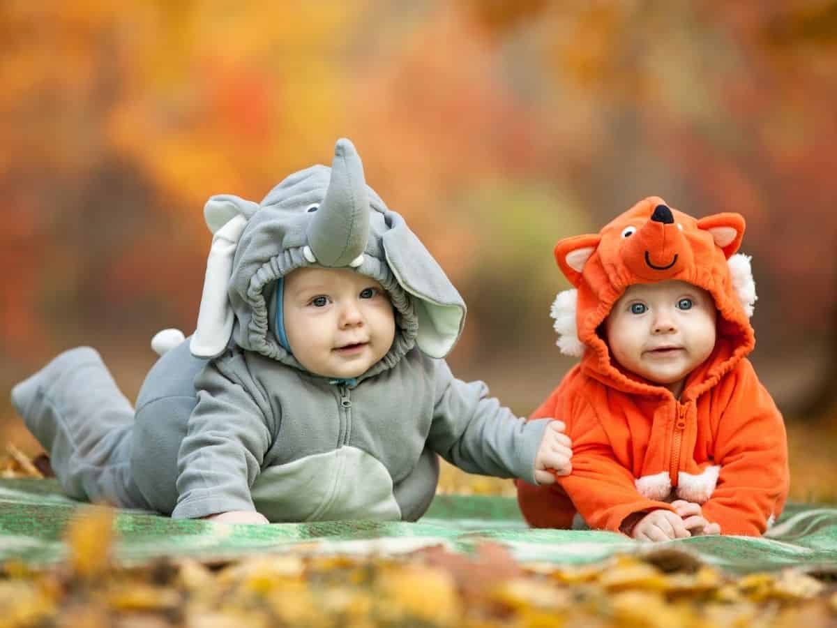 two babies dressed up for Halloween in animal costumes