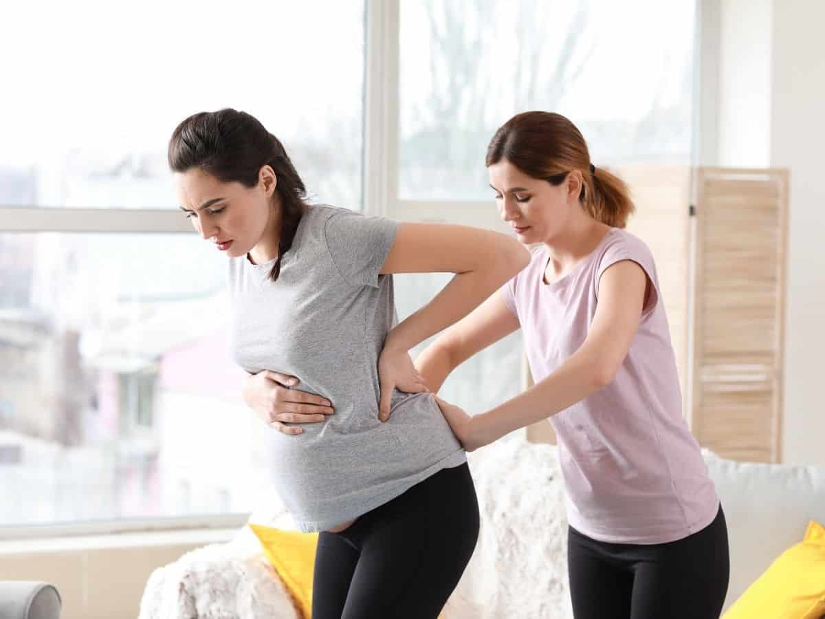 a pregnant woman with a doula supporting her