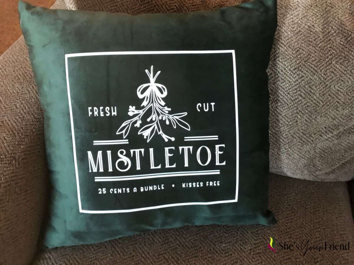 a green velvet throw pillow cover that says mistletoe on it