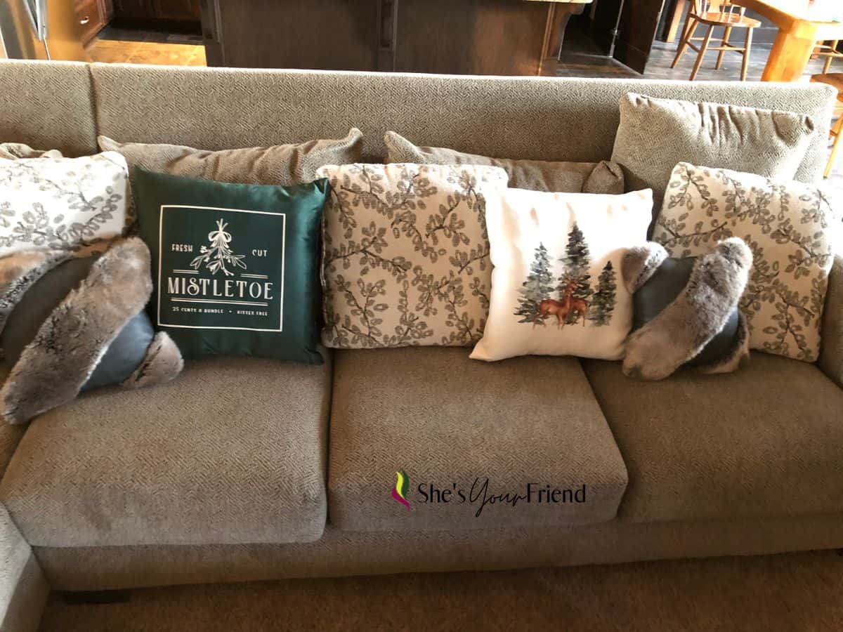 a couch with mix and match Christmas throw pillows